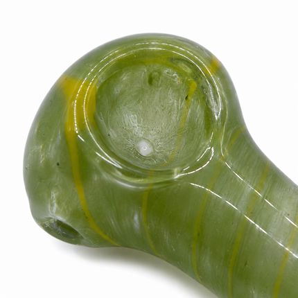 Close-up of translucent green glass spoon pipe bowl and rounded glass detail