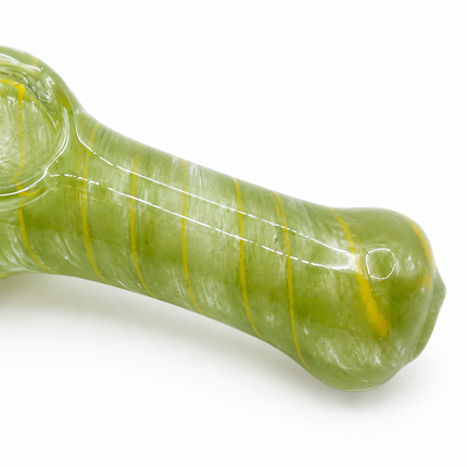 Side close-up of green glass spoon hand pipe showing textured glass body