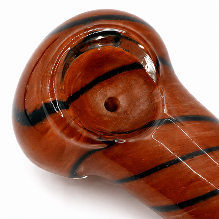 Close-up of red brown striped glass spoon pipe bowl and carb hole