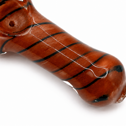 Close-up of red brown glass spoon pipe body showing dark spiral stripe design