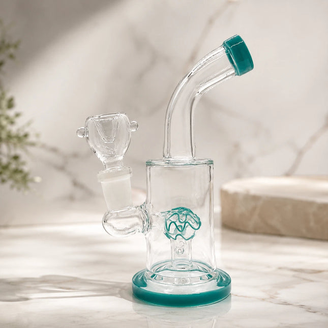 Clear ocean teal 6-inch mini glass bong with curved neck and dome percolator displayed on a soft marble background