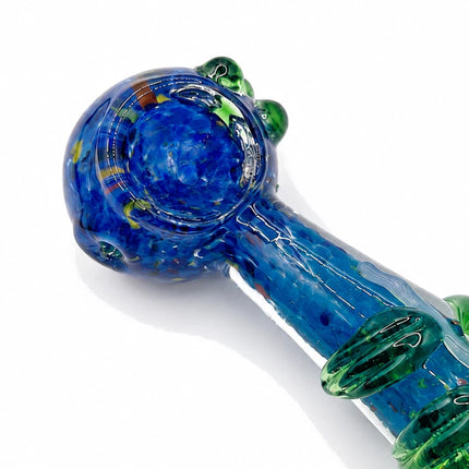 Close-up of the bowl area showing cobalt blue glass, intricate internal swirls, and raised green decorative accents