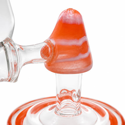 Close-up of the internal orange cone percolator and matching circular base detail inside the glass chamber