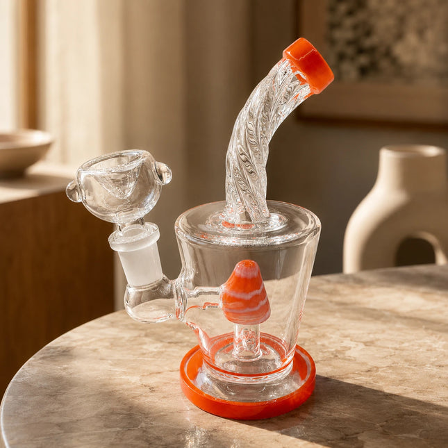 Orange-accented mini water pipe staged on a warm stone tabletop with soft neutral decor and natural window light