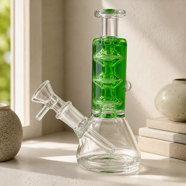 Emerald glycerin stack glass beaker water pipe displayed on a neutral tabletop with soft indoor lighting