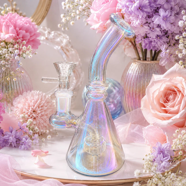 Crystal iridescent chrome beaker glass water pipe styled in a floral pastel setting with soft decorative lighting