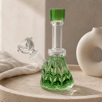 Green fluted mini glass water bong pipe with clear neck and 14mm bowl displayed on a neutral tabletop background