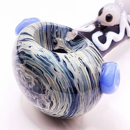 Close-up of the rounded bowl area with gray marbling, blue side knobs, and bold black-and-white spider-inspired design