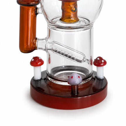 Detailed view of the clear chamber and red mushroom-style percolator above a round base with earthy red-brown trim