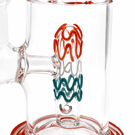 Close-up of the chamber highlighting the red and teal decorative glass artwork inside the transparent body