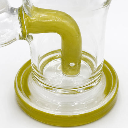 Close-up of the lime-colored curved inner tube and circular base inside the clear chamber