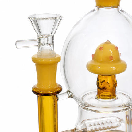Partial side view showing the 14mm glass bowl and amber mushroom perc inside the clear chamber