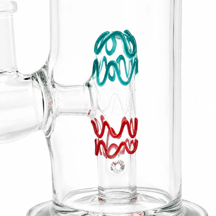 Close-up of the central chamber showing the blue and red decorative wave design inside the clear glass bong