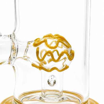 Close-up of the yellow dome percolator suspended inside the transparent chamber with matching base trim