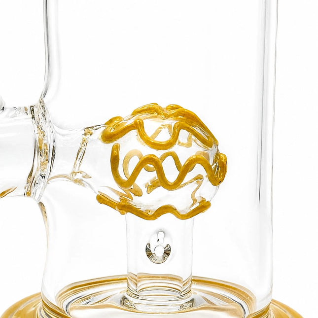 Close-up of the yellow dome percolator suspended inside the transparent chamber with matching base trim
