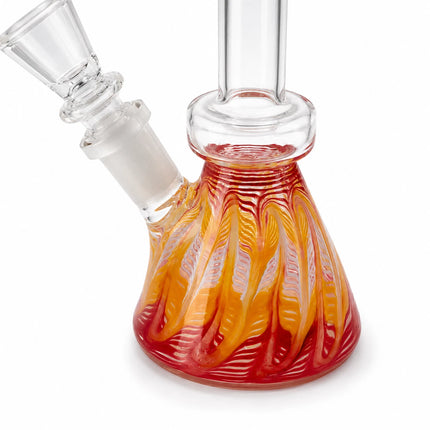 Angled close view highlighting the flame-like pink, amber, and red swirl pattern across the compact beaker chamber