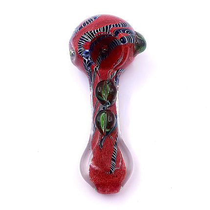 Full-length vertical view of the red glass spoon pipe emphasizing its compact shape, rounded bowl, and decorative raised features