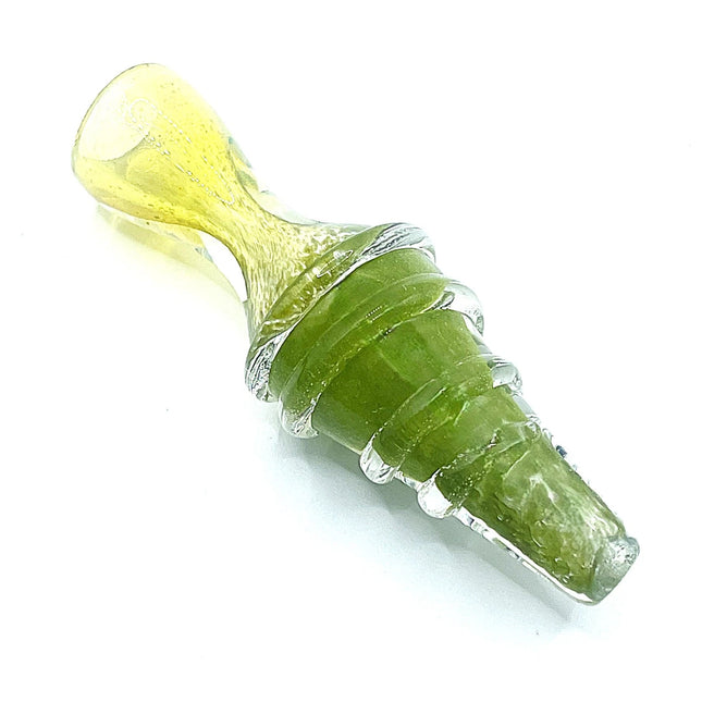 Angled studio view of a compact olive green ribbed chillum pipe with a translucent pale yellow mouthpiece on a white background.