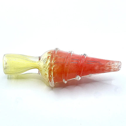 Side profile of a small coral pink glass chillum with spiral ribbing and a pale translucent mouthpiece photographed on a plain light background.