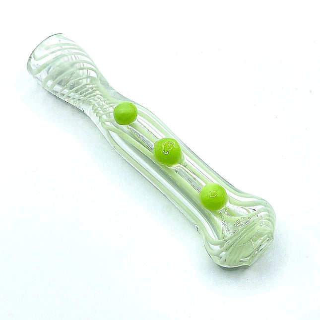 Angled studio view showing the transparent glass body, rounded spoon bowl, and evenly spaced green dot accents.