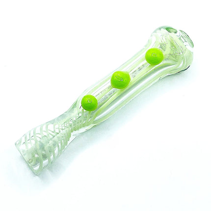 Reverse diagonal angle highlighting the raised melon green grips, textured clear glass, and compact hand-pipe shape.