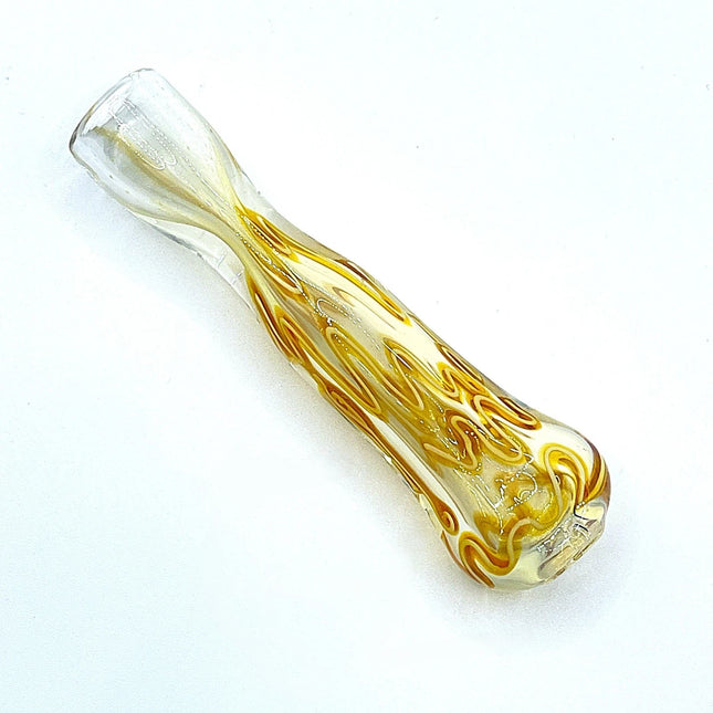 Top view of a compact amber glass chillum with flowing swirl pattern on a clean white background