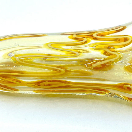 Close-up macro view of the golden swirl pattern running through the body of the glass chillum