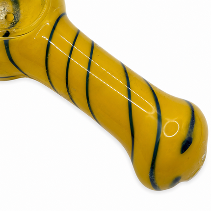 Close-up of yellow glass spoon pipe body with dark spiral stripe detail